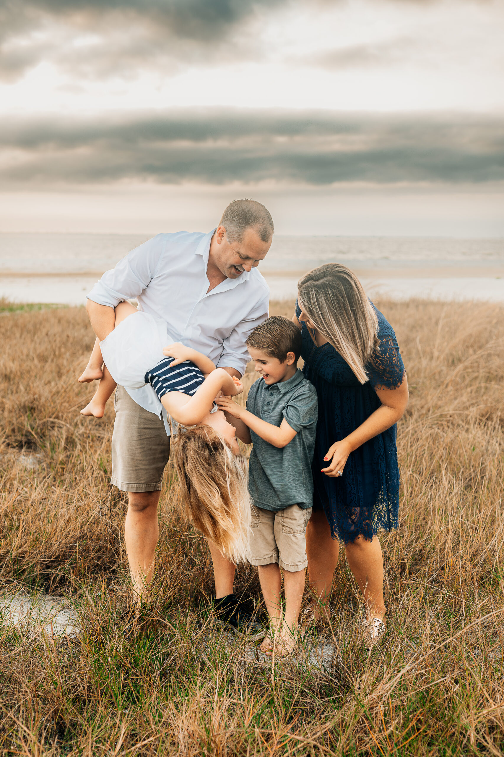 Family beach session at bowditch point park fort myers, florida family wearing navy blue color scheme